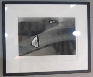 Framed photograph showing a close up of the 'wings' badge found on an Aston Martin V12 Engine
