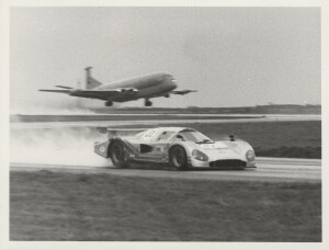 Photograph of Nimrod car racing a Nimrod Aircraft