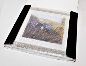 Framed presentation image of an Aston Martin DB9 from the Millbrook Performance Driving Course, in a box